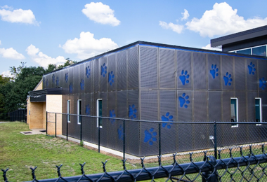 Perforated metal façade panels installed on an elementary school building.