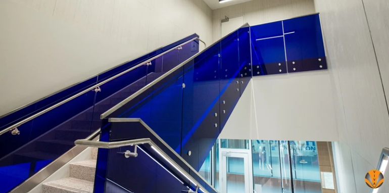 An image of custom blue glass infills in a hallway stairs.