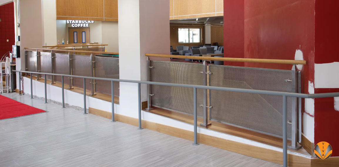 nterior mezzanine with metal railing and mesh panels in renovated commercial space.