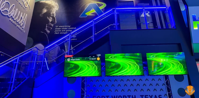 An image of a glass railing system with LED lighting inside an arcade.