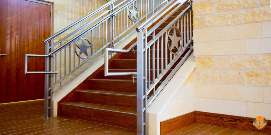 Interior staircase with custom stainless steel railings featuring star-shaped design accents.