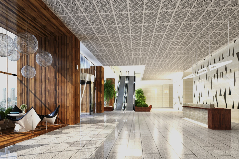 Large commercial lobby with decorative patterned ceiling panels.