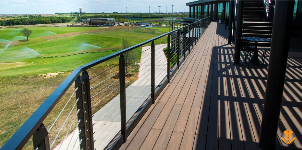 Elevated deck with cable railings overlooking a golf course.